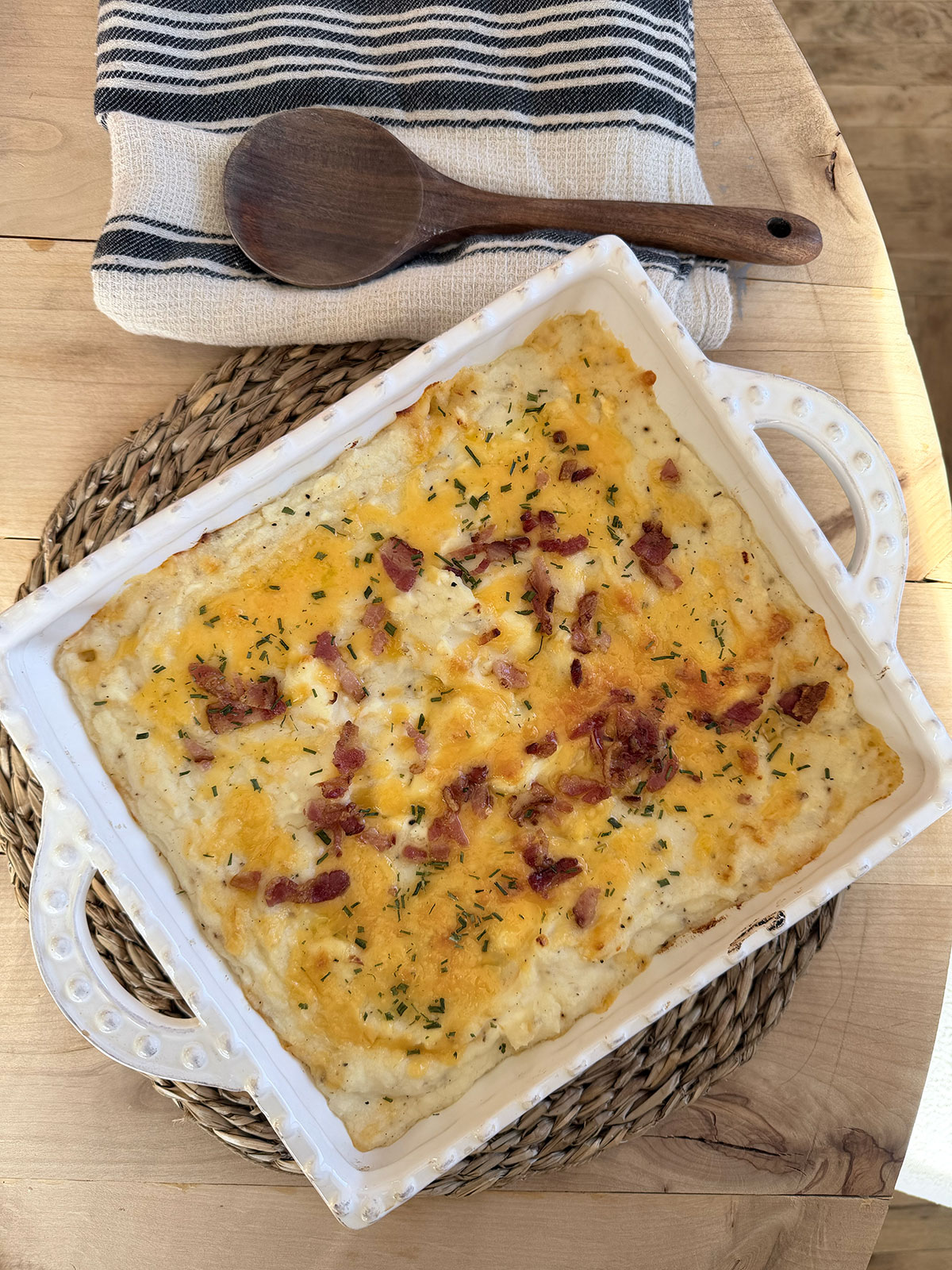 Twice baked mashed potatoes in a white baking dish.