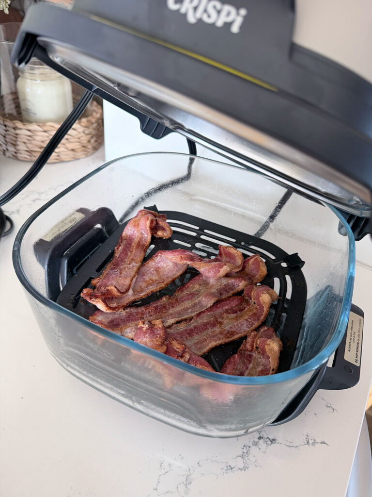 cooked bacon in basket of air fryer