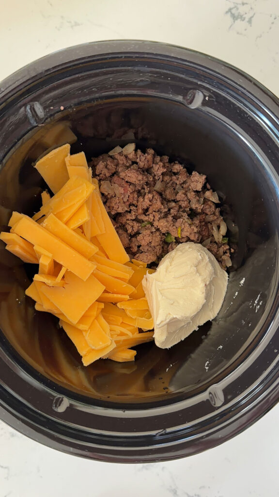 ground beef, shredded cheese, cream cheese and spices in crockpot.