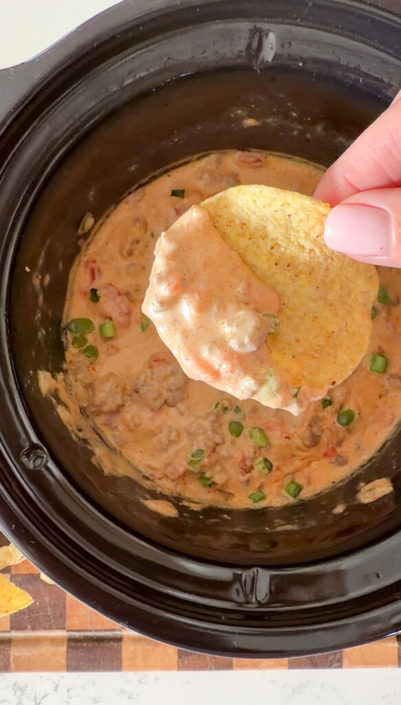 tortilla chip with dip on it.