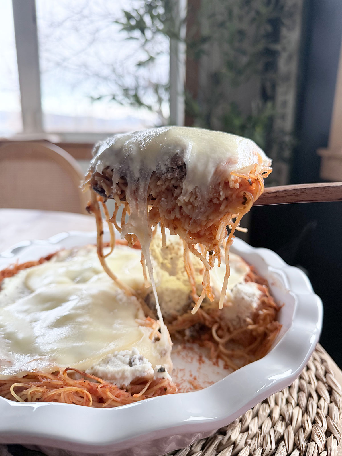 side profile of slice of spaghetti pie removed from baking dish