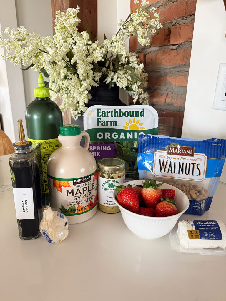 Strawberry Goat Cheese Salad Ingredients on counter with flowers in background