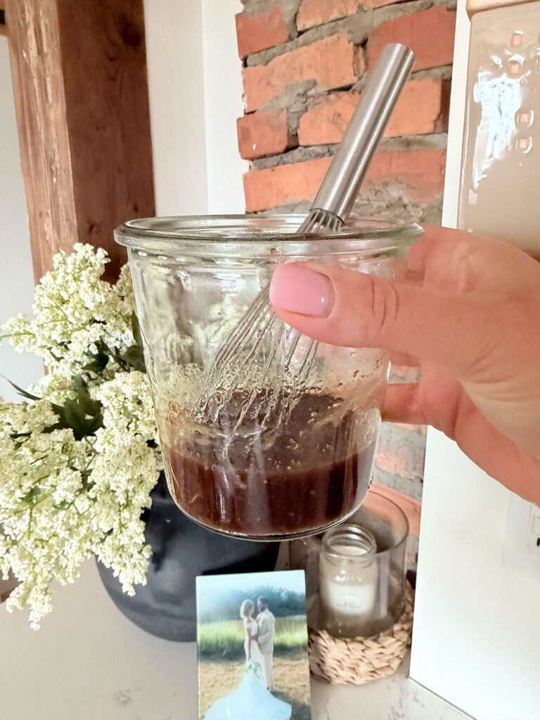 Strawberry Goat Cheese Salad vinaigrette in glass jar with whisk