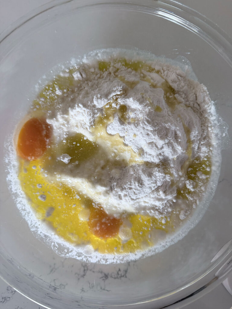 coconut poke cake dry and wet ingredients in bowl unmixed