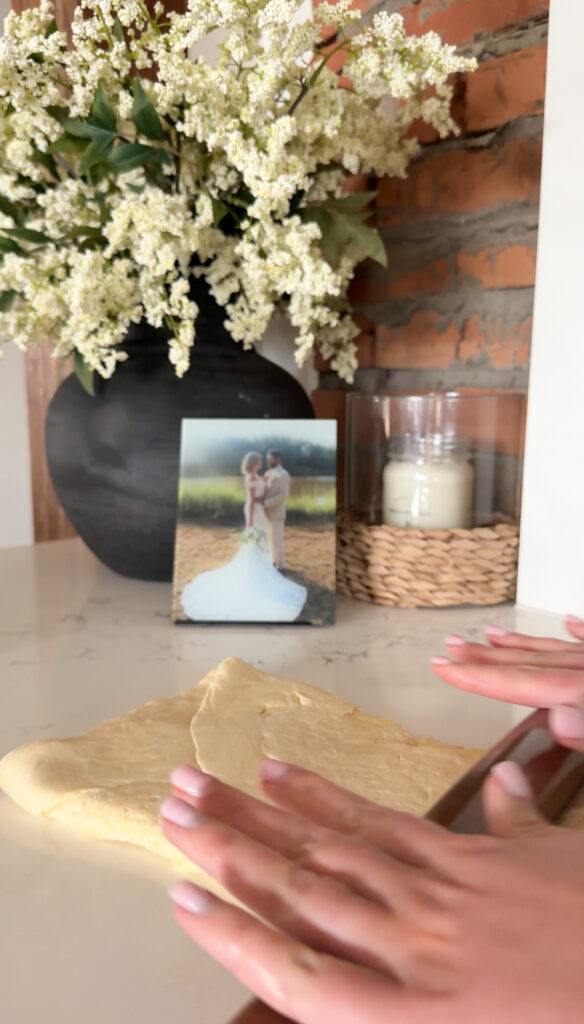 rolling out the dough after being folded. 
