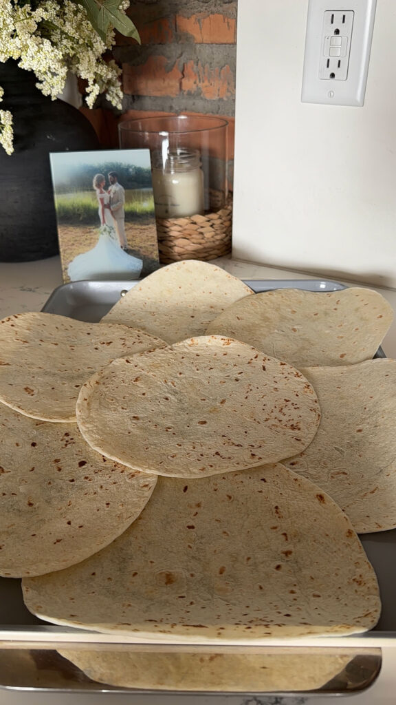tortillas layered on sheet pan
