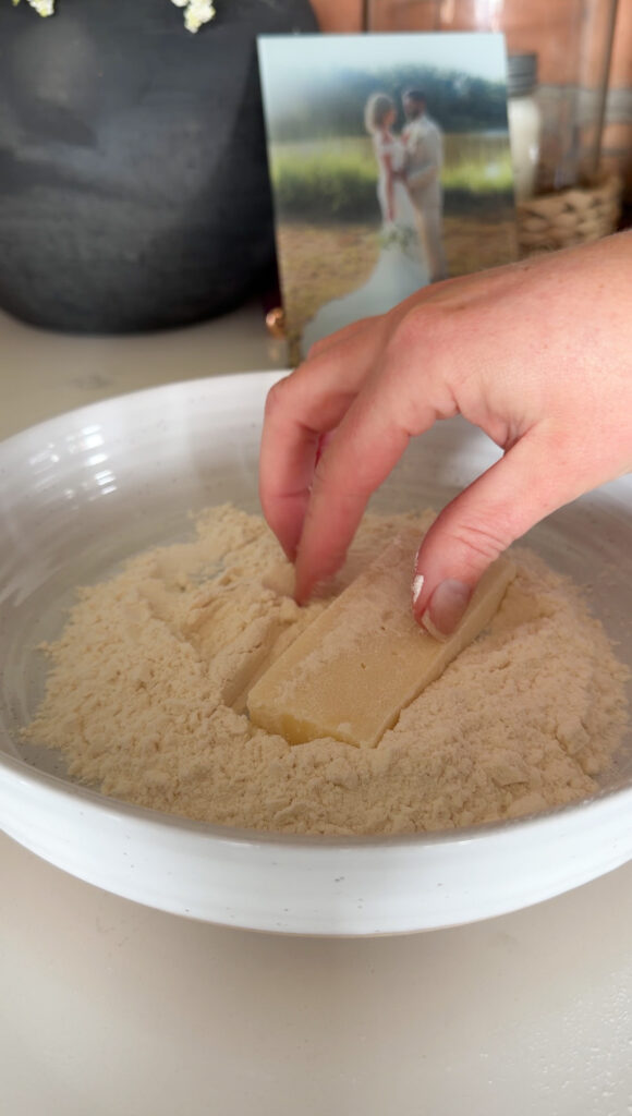 putting the cheese into flour