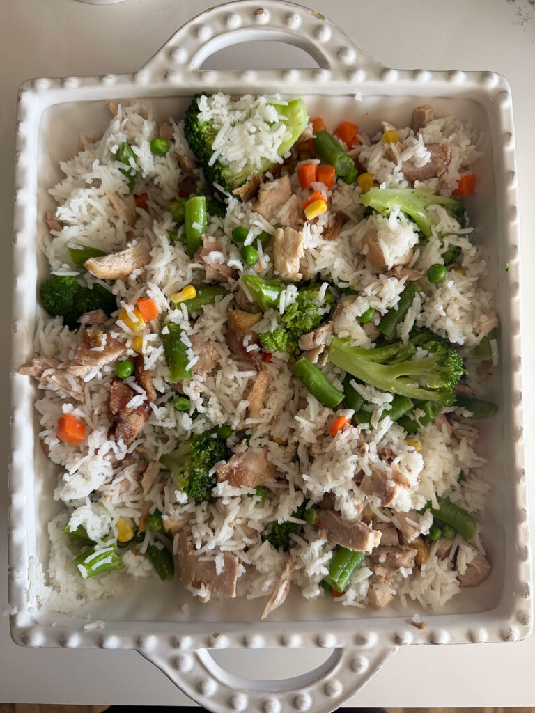 chicken teriyaki casserole ingredients in white baking dish ready to be baked