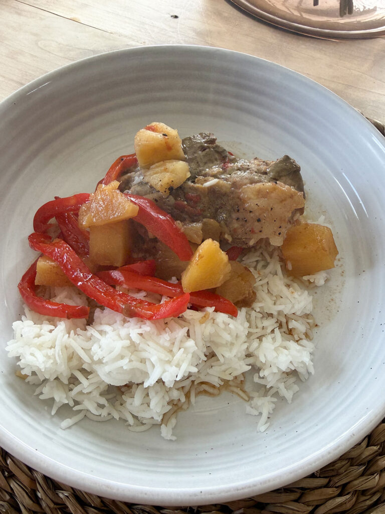 sweet and sour pork plated with rice on white plate