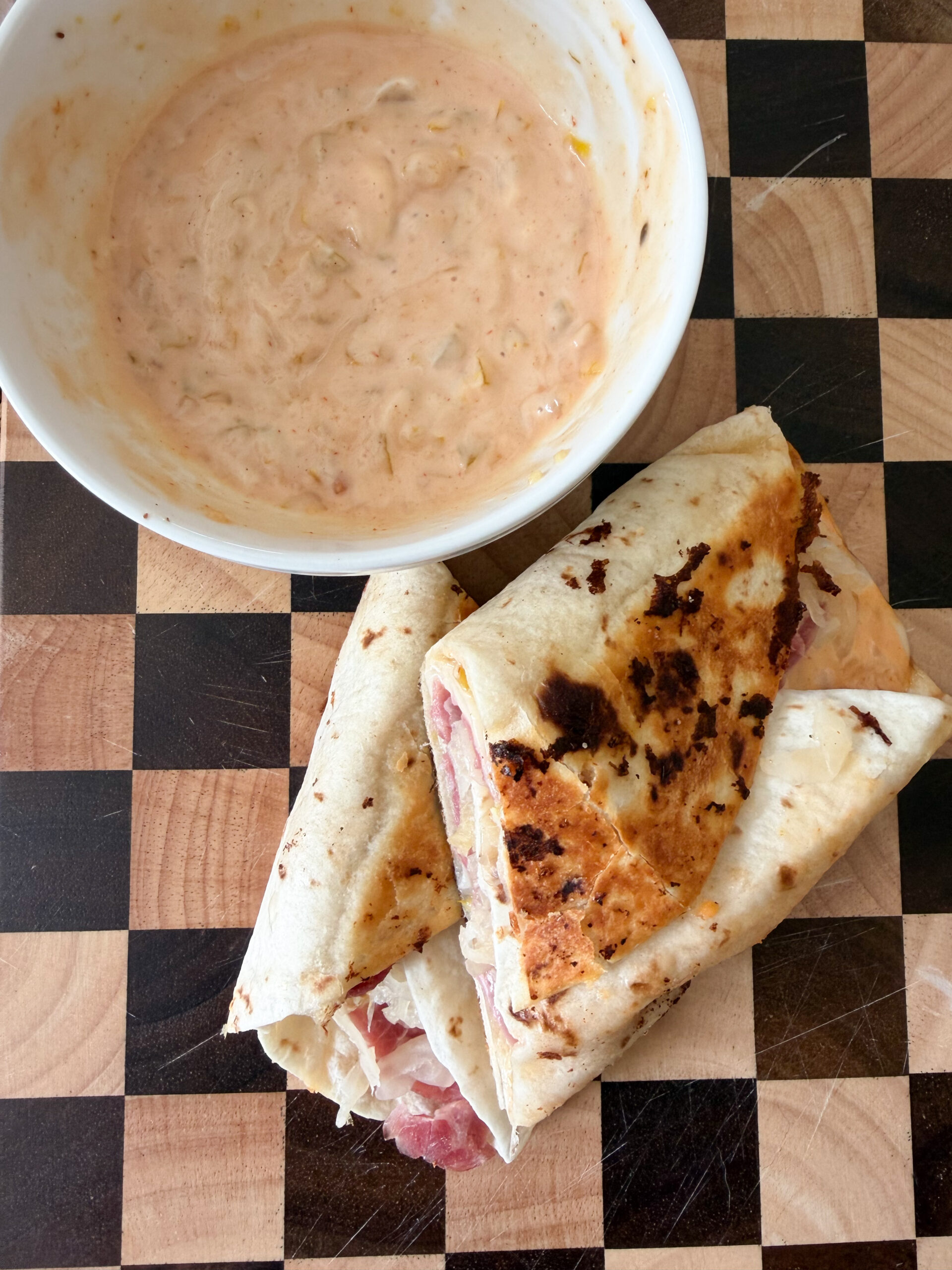 reuben displayed next to dressing.