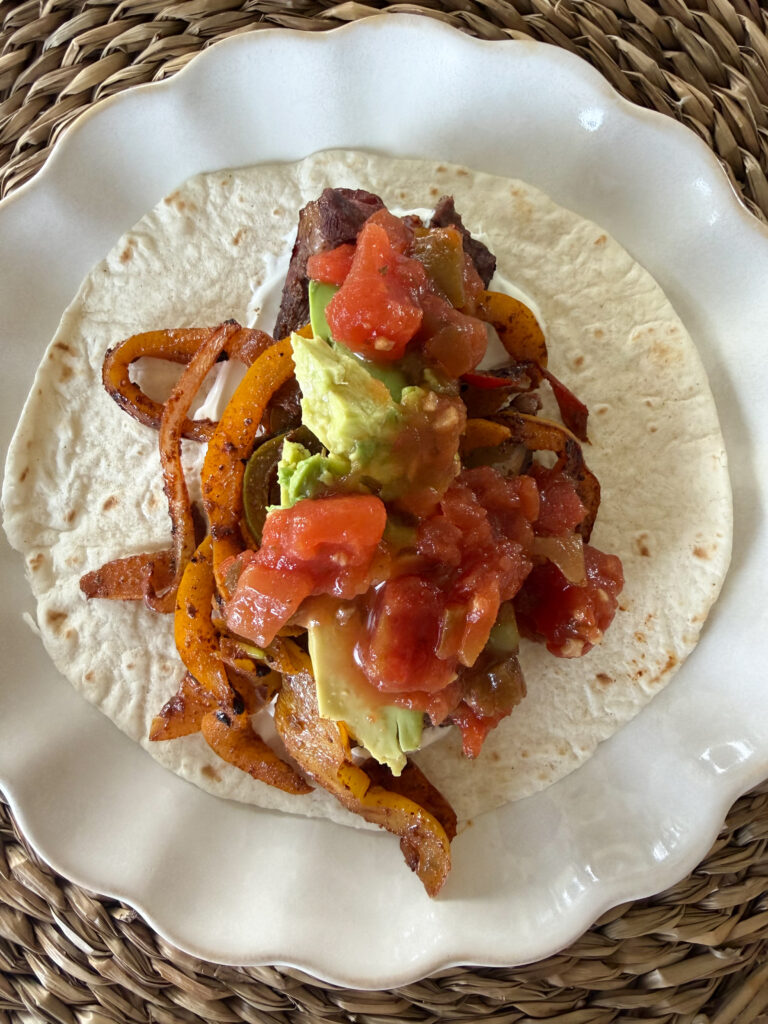 fajita plated on a soft shell tortilla