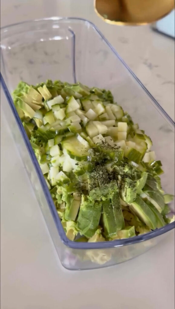 pickle guacamole ingredients in clear base of food chopper