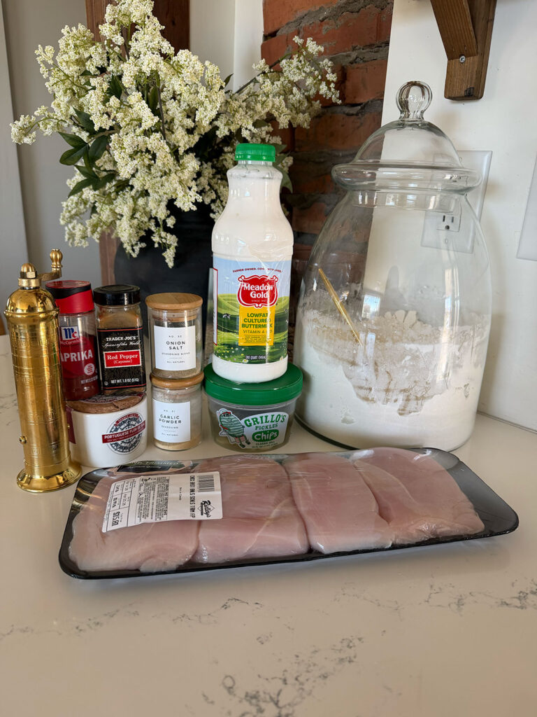 pickle brined fried chicken ingredients on counter with vase of flowers in background