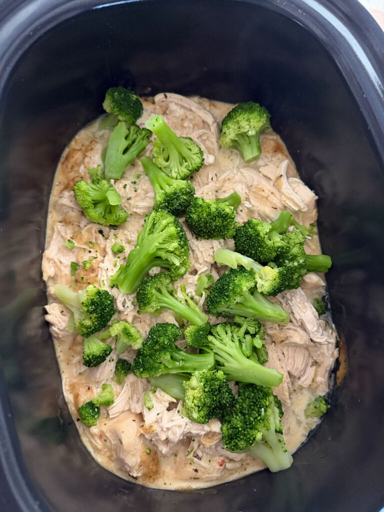 broccoli florets added to cream chicken mixture in slow cooker