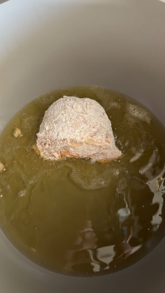 coated chicken frying in oil