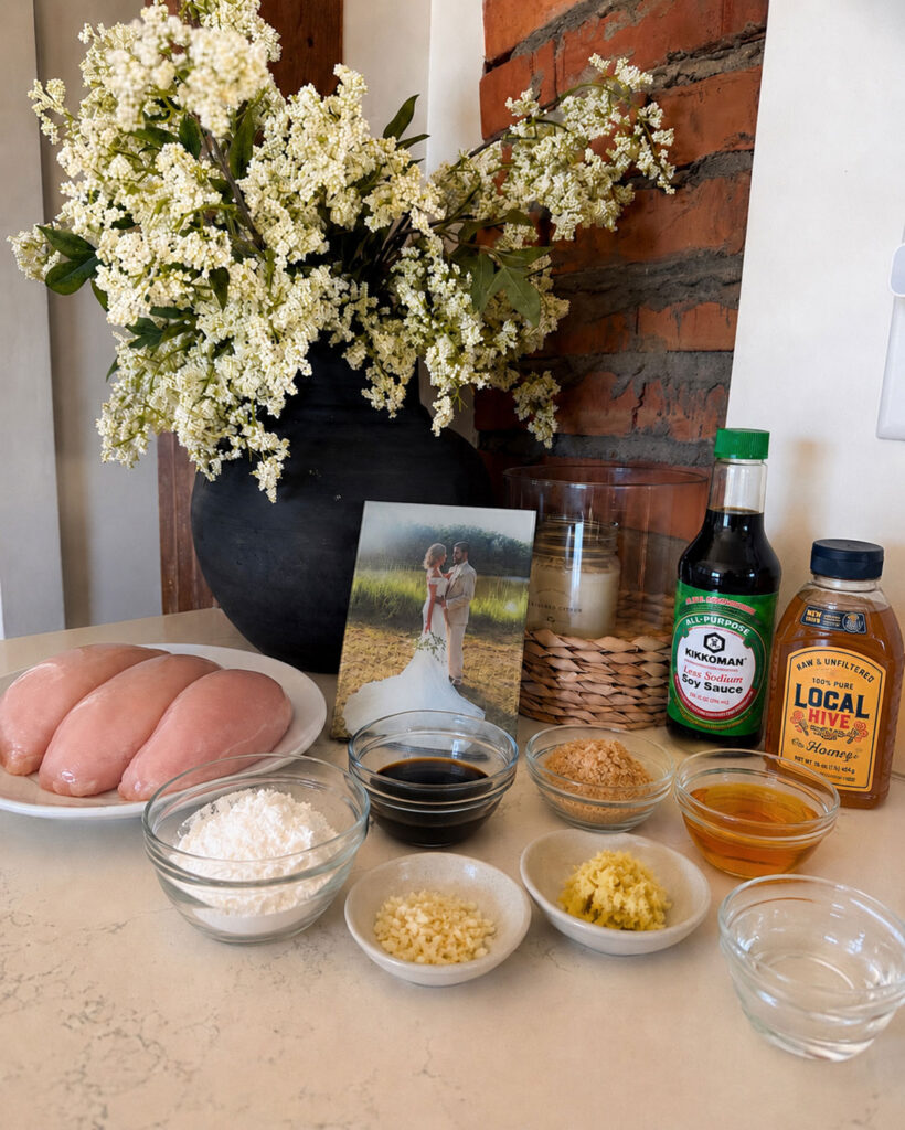 oven baked chicken teriyaki ingredients on counter with vase of flowers in background