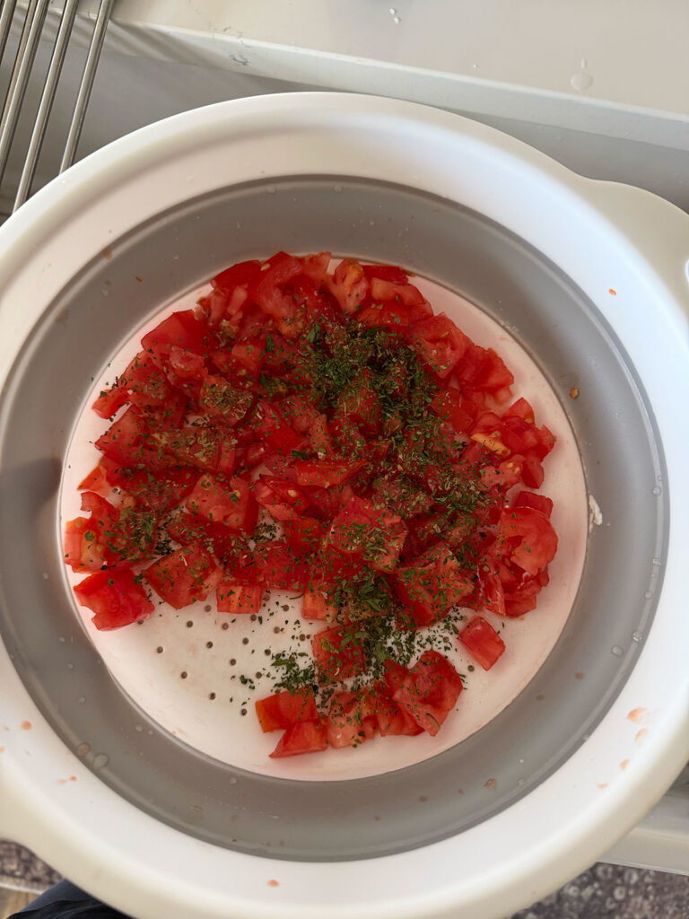 tomatoes and seasonings in mixing bowl