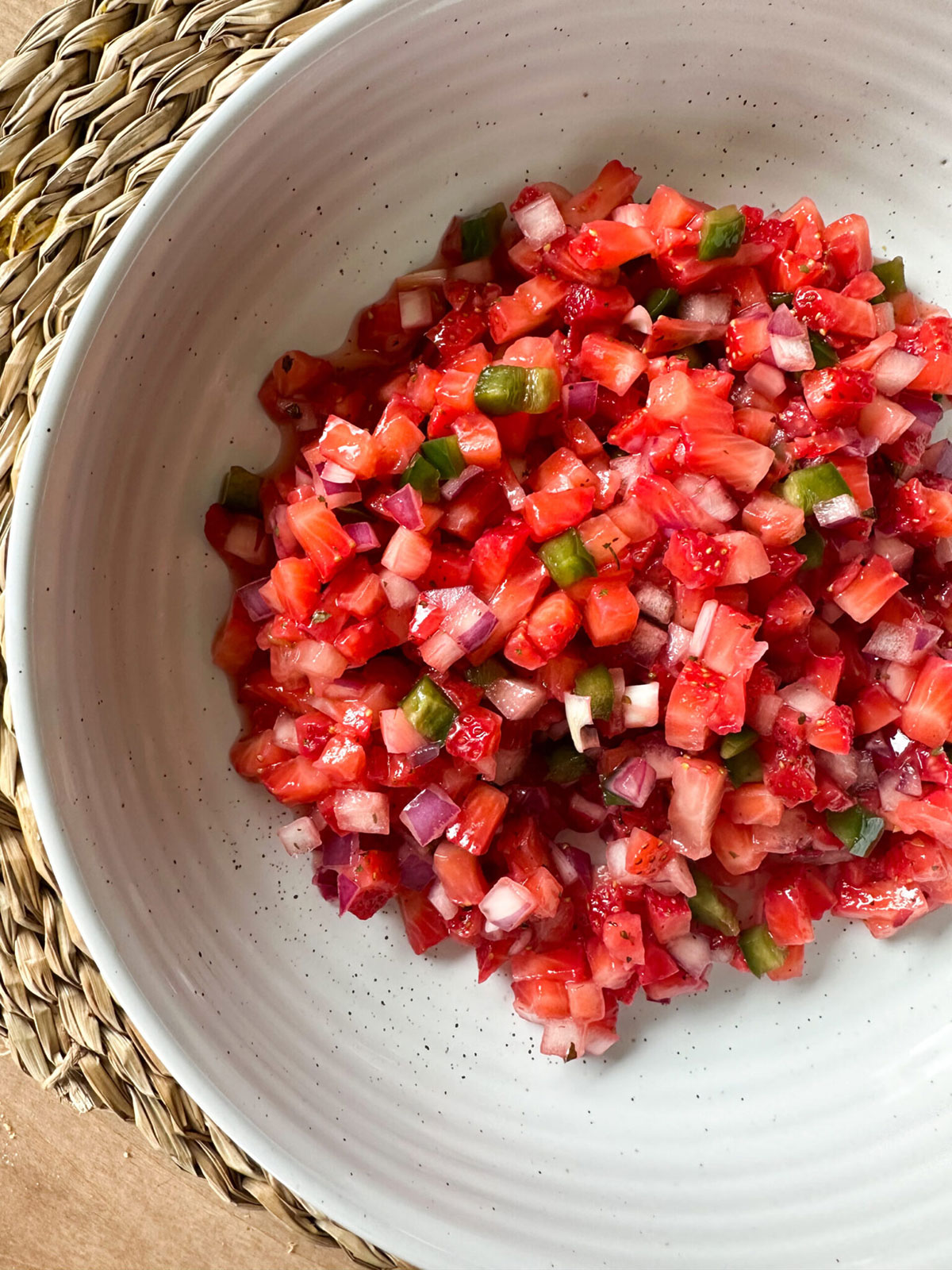 A white bowl with strawberry salsa.