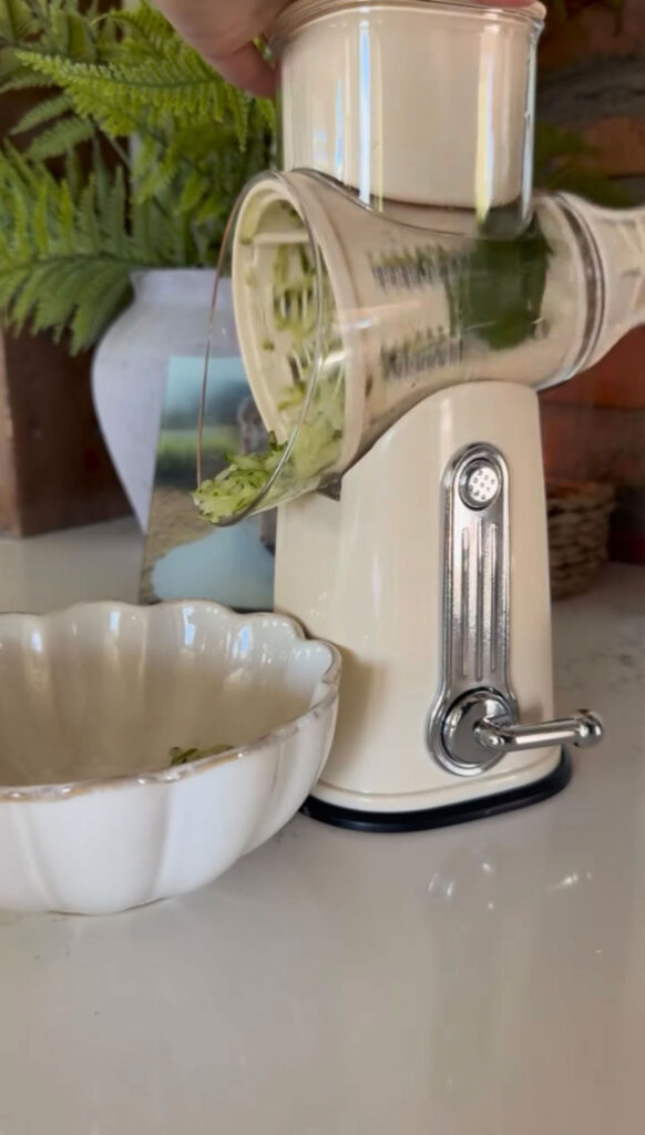 Shredding pickles into a bowl.