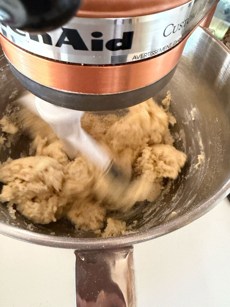 A stand mixer mixing butter and sugar for flag cake.