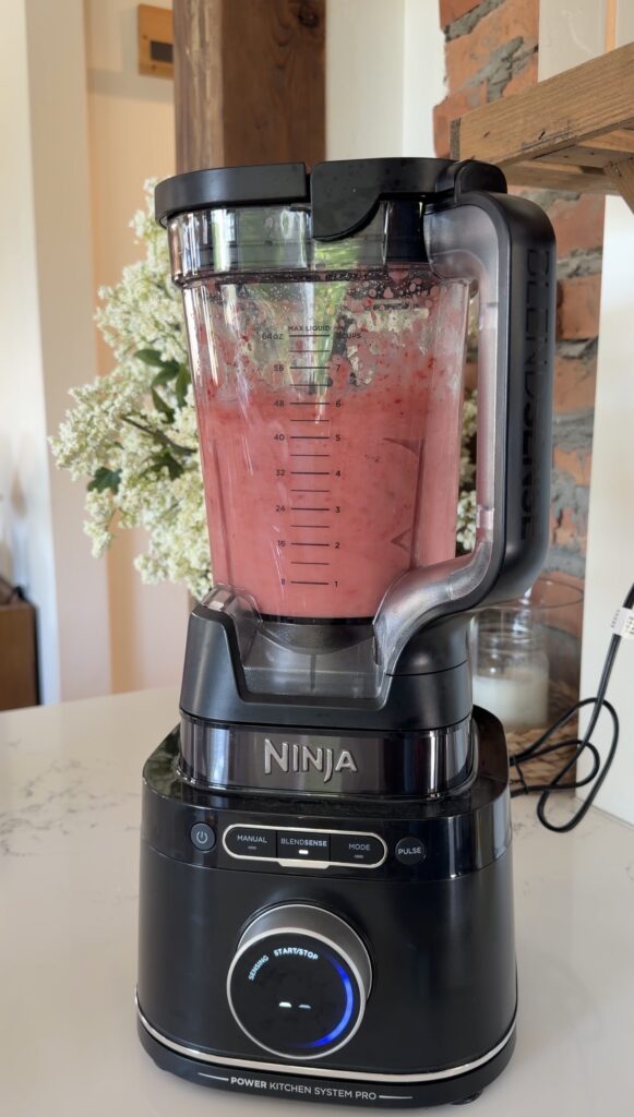 mixing the strawberries with lemonade
