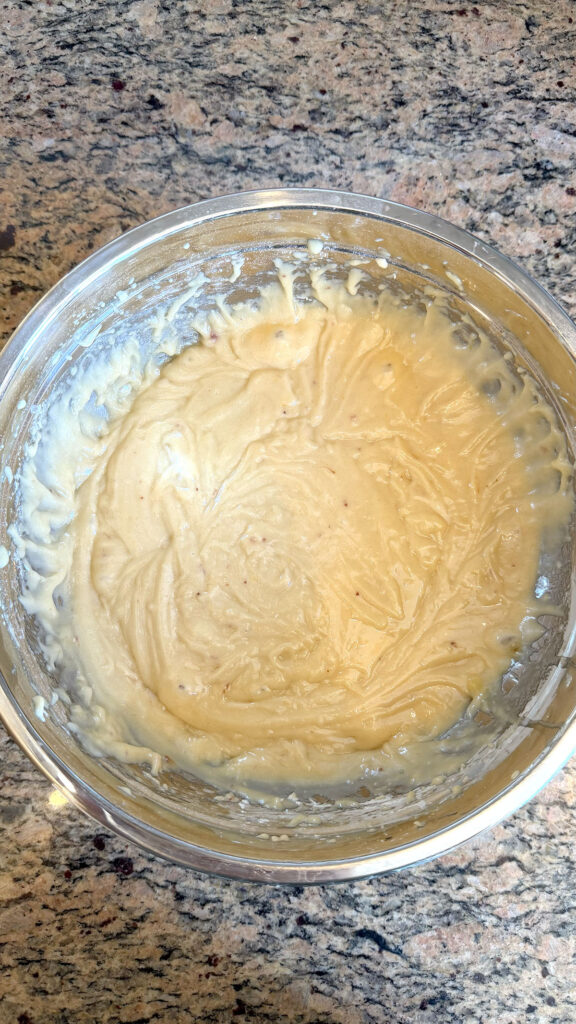 Cake batter for strawberry bundt cake in a metal bowl.
