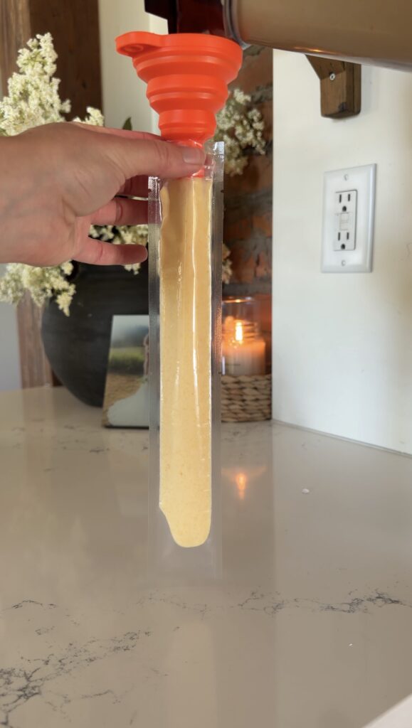 ingredients being poured in freeze pop mold