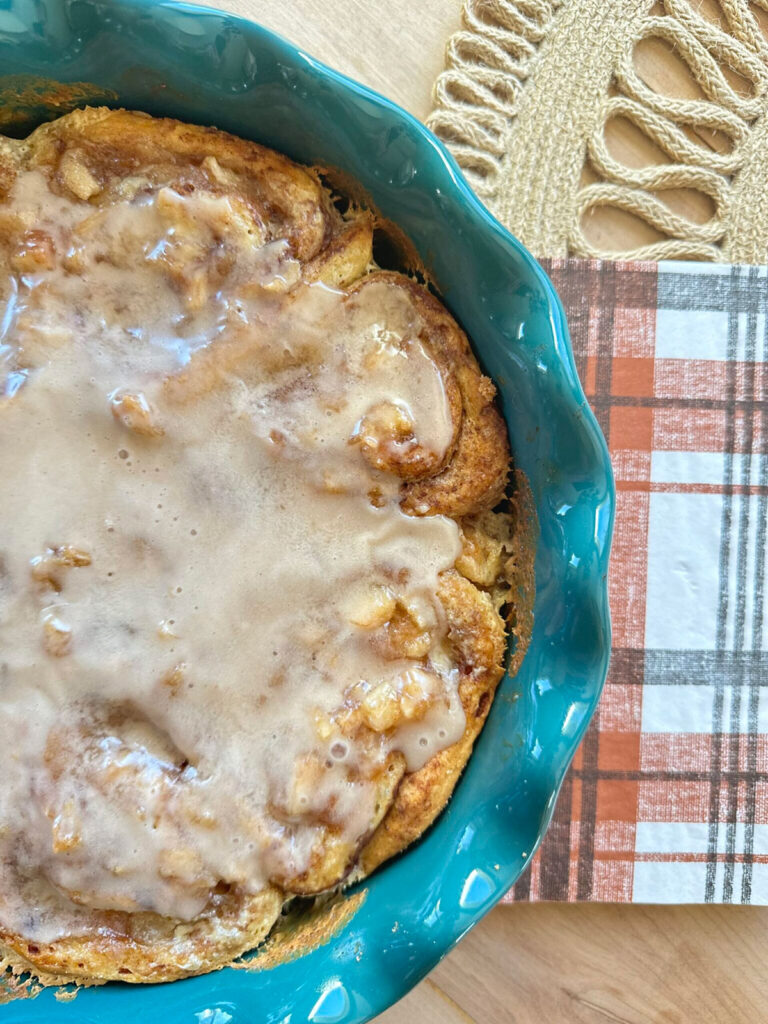 baked cinnamon rolls in blue pie plate
