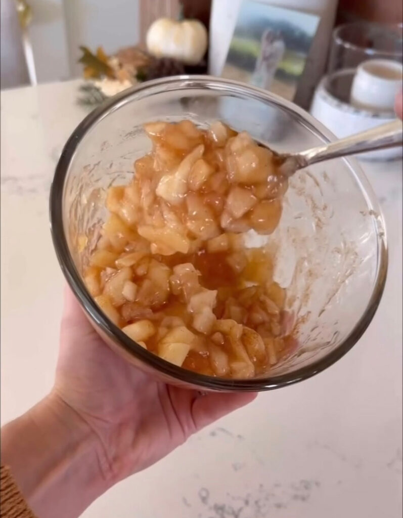 apple pie filling in clear bowl with spoon