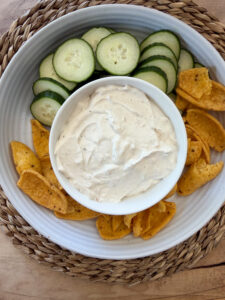 dip in a bowl with chips and veggies