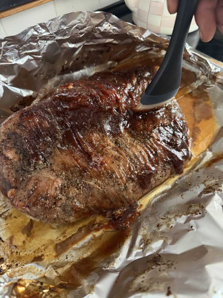 brushing bbq sauce on