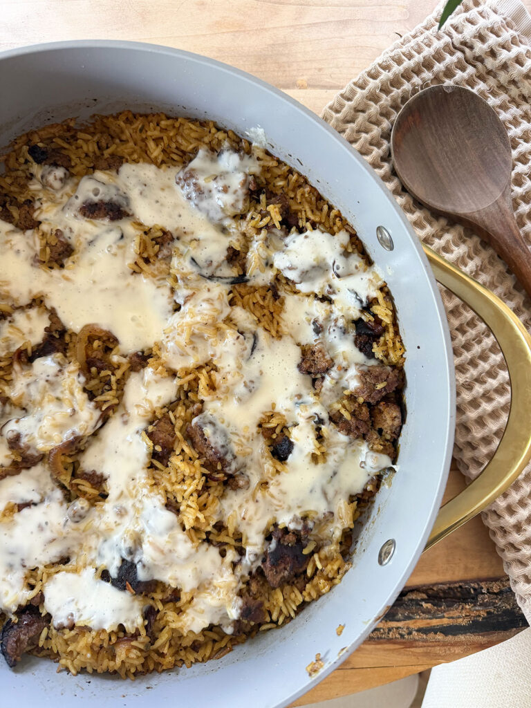 close up view of finished french onion ground beef casserole with wooden spoon next to it