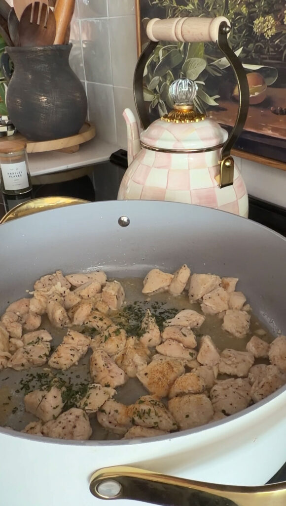 chicken browning in pan with spices