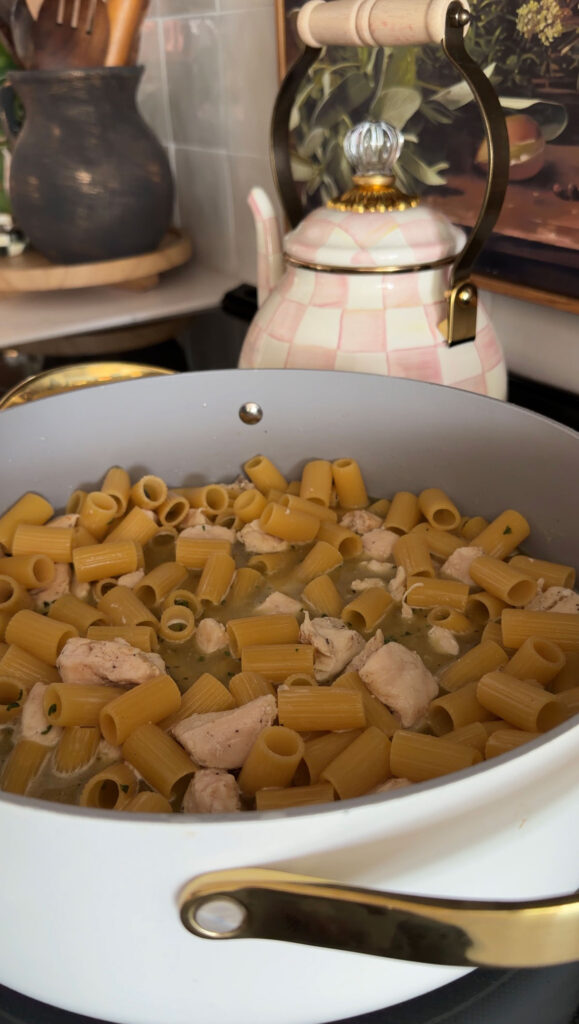 pasta, chicken and broth cooking in pan