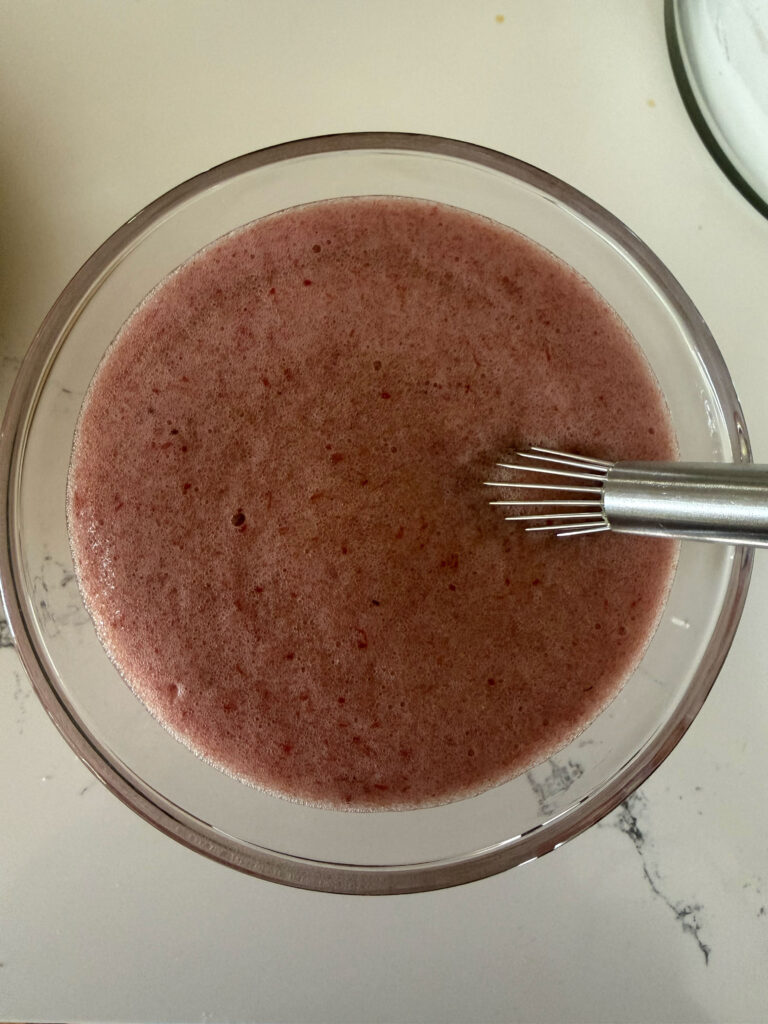 applesauce liquid ingredients with whisk in glass bowl