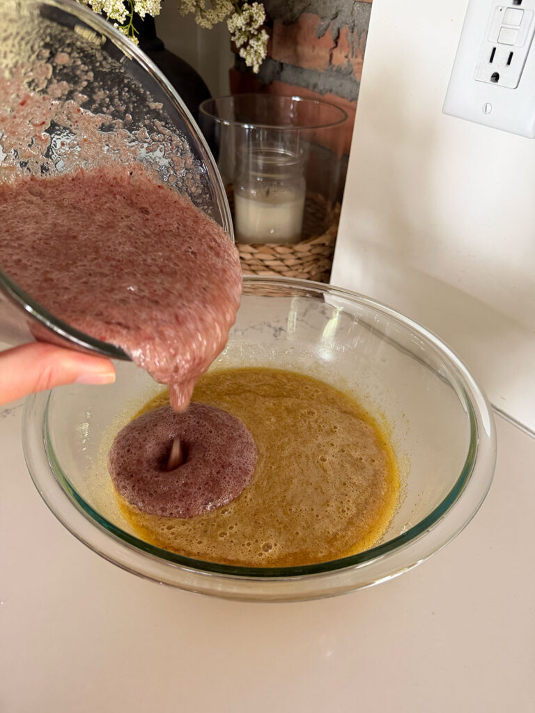 applesauce added to liquid ingredients in glass bowl