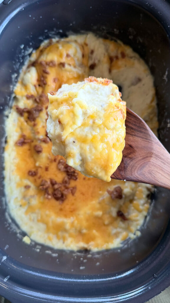 spoonful of potatoes over crockpot of potatoes