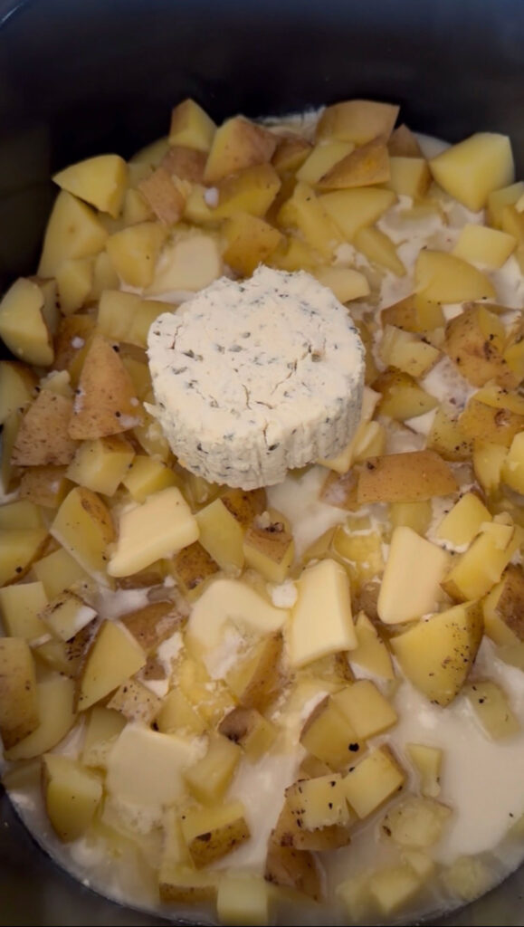diced uncooked potatoes, milk and boursin cheese in crockpot