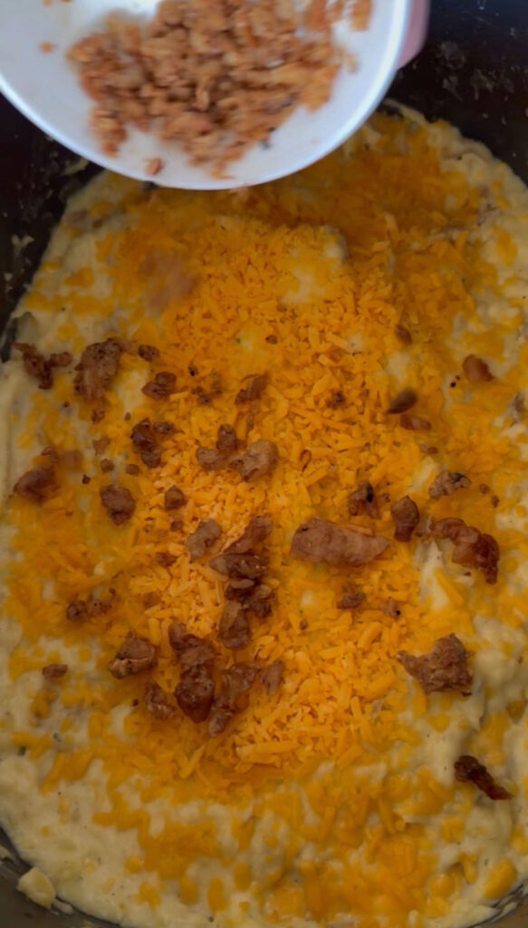 crockpot mashed potatoes topped with more cheese and bacon