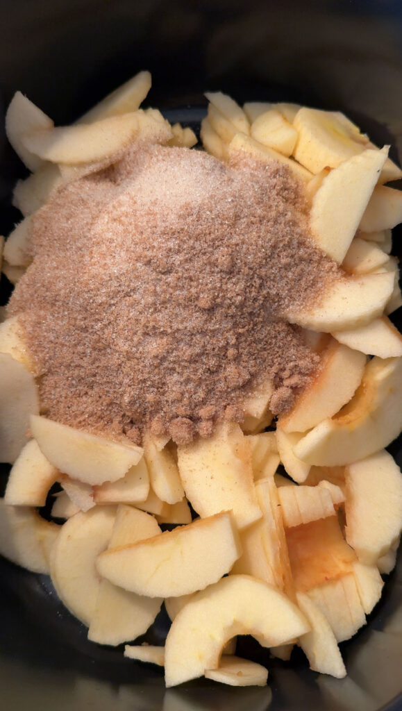 spices and sugar on top of sliced apples
