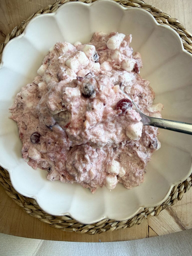 cranberry fluff in white scalloped bowl with spoon