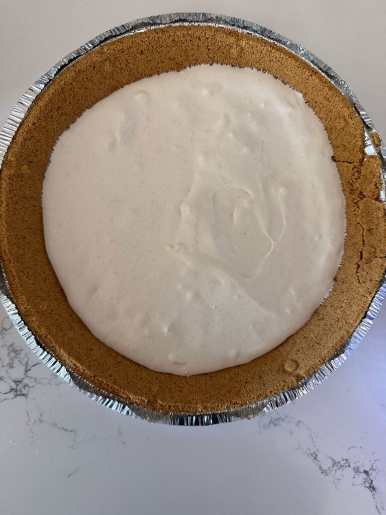 crust with pudding and whipped topping in bottom