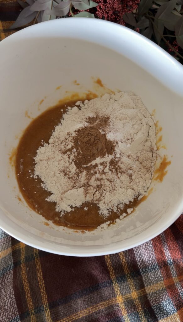 adding pumpkin muffin ingredients
