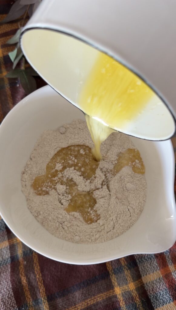 adding melted butter to streusel mix