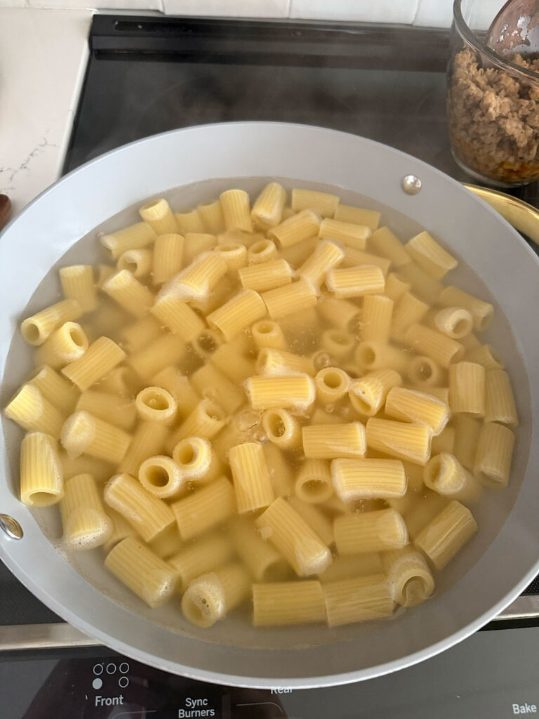 A pot boiling rigatoni noodles.