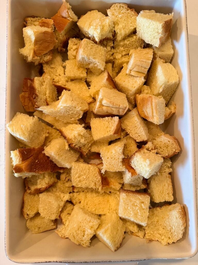 A baking dish with bread cubes.