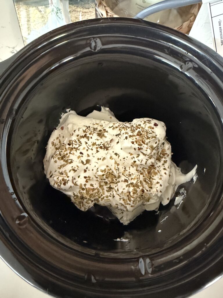 cream cheese, spices and sour cream in crockpot