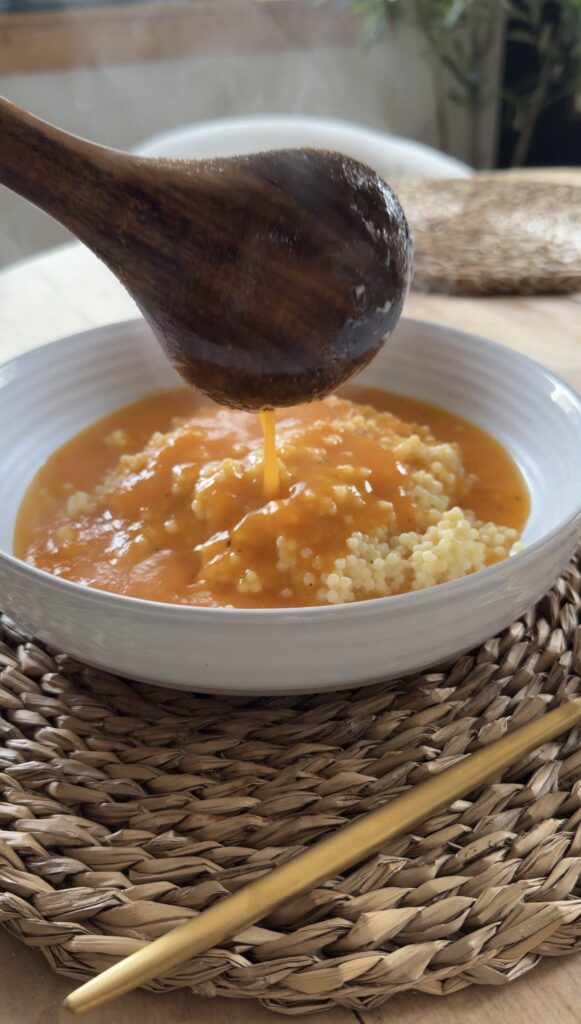 broth being spooned over pastina