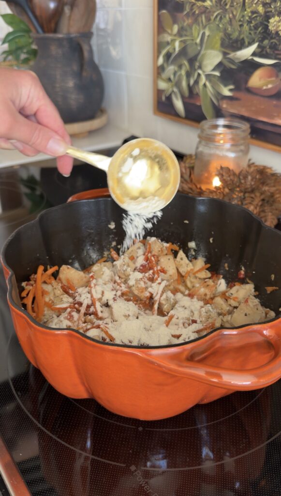 adding tomato paste and flour to pot