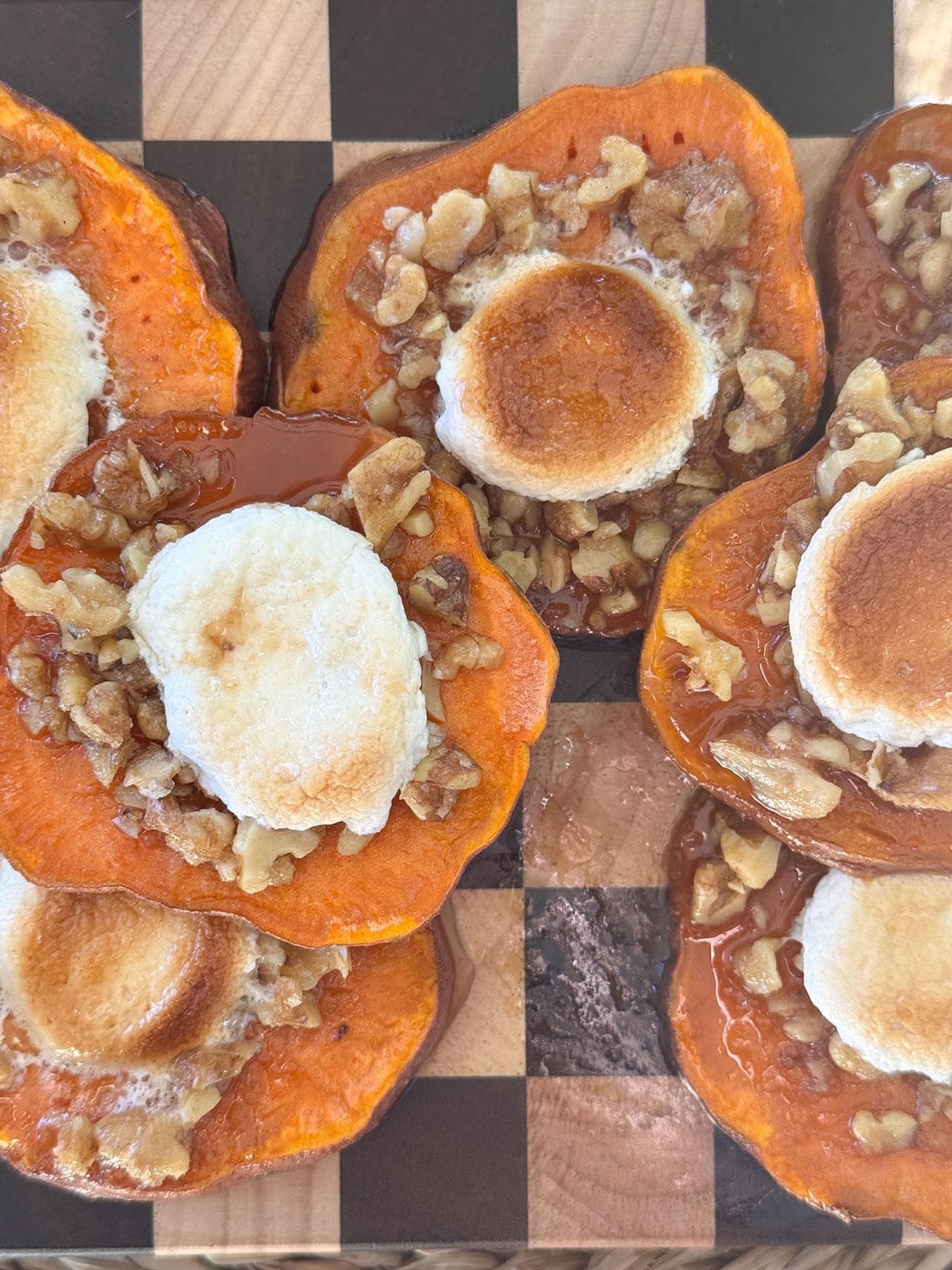 baked sweet potato casserole bites topped with pecan topping and marshmallows
